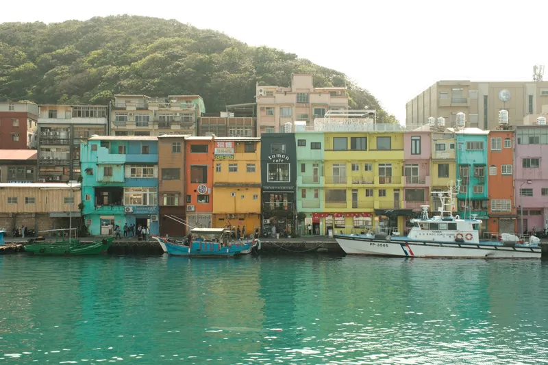 Colorful waterfront buildings with boats docked along Keelung harbor